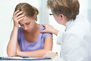 Distraught female patient with counselor